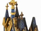 a blue and gold clock with a clock tower on it