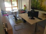 a desk with a computer on it and a chair in front of it