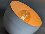 the light is on in the concrete bowl on the table