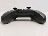 a close up of a black controller on a table