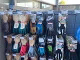 several pairs of gardening gloves are on display in a store
