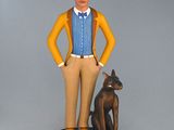 figurine of a man with glasses and a dog on a pedestal