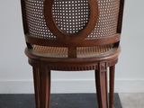 a wooden chair with a cane back and a cane seat