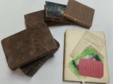 several old books are stacked on top of each other on a table