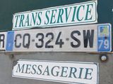 many street signs on the back of a truck