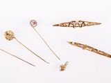 several different types of hair pins and brooches on a white surface