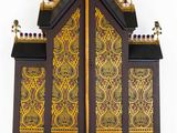 a wooden cabinet with a cross on top of it