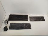 two keyboards and a mouse sitting on a table