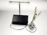 a solar powered lamp and a vase with flowers in it