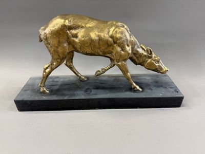 bronze sculpture of a bull on a marble base on a gray background