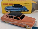 a toy car that is sitting in front of a box