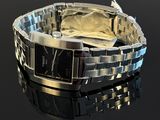 a close up of a watch on a black surface