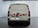 a white van with red and white stripes parked in a room