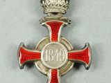 an image of a red and silver cross with a crown on it