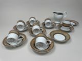 many cups and saucers sitting on the table