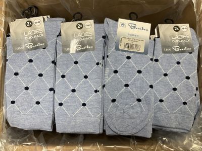 three pairs of men ' s socks in a box on a plastic wrapper