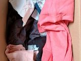 a cardboard box filled with clothes and other items