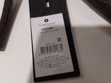 a black bag with a tag on it sitting on a table
