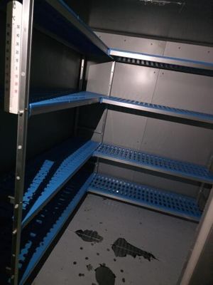 a blue shelf in the middle of a room