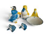three figurines of birds that are sitting next to each other