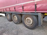 a large red truck that is parked on the side of the road