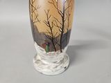 a vase with a painting on it on a table