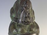 sculpture of a woman ' s head with a woman sitting on top of her head