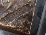 a close up of a piece of metal with writing on it