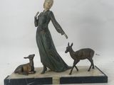 statue of a woman with a deer and a dog on a marble base