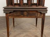 an old wooden birdcage on a table in a room with parquets