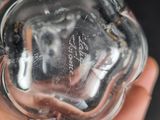 a person holding a clear glass object in their hand