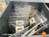 many bags of food inside of a bin on the floor