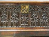 a very old wooden chest with a brass plate on it