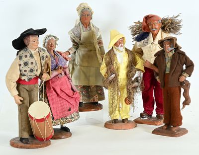 five figurines of people dressed in traditional clothing