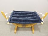 a hammock that is on a wooden stand