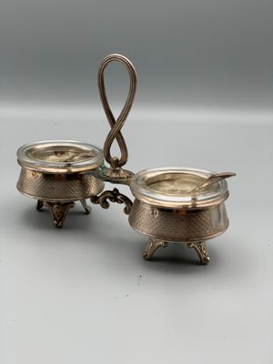 a pair of silverplated dishes with handles and handles