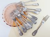 a lot of silverware on a plate on a table