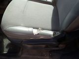 the seat of a car with a piece of paper sticking out of it