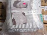 a pillow that is wrapped in plastic on a table