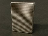 a silver lighter sitting on a table with a black background