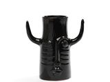 a black vase with a face and horns on it