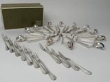 a lot of forks and spoons that are on the table