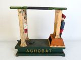 a wooden toy of a man and a woman on a scale