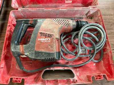 a red box with a drill in it on a table