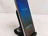 a close up of a cell phone on a stand on a table