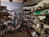 a room filled with lots of metal pots and pans