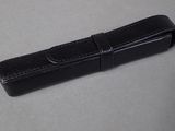 a black leather case with a metal clasp on it