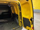 a yellow van with the door open on the street