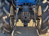a tractor that is parked in the dirt