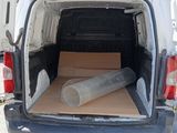 a white van with a large roll of material in the back